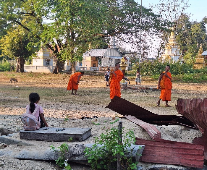 Monks on passing through the school grounds to start their English lesson