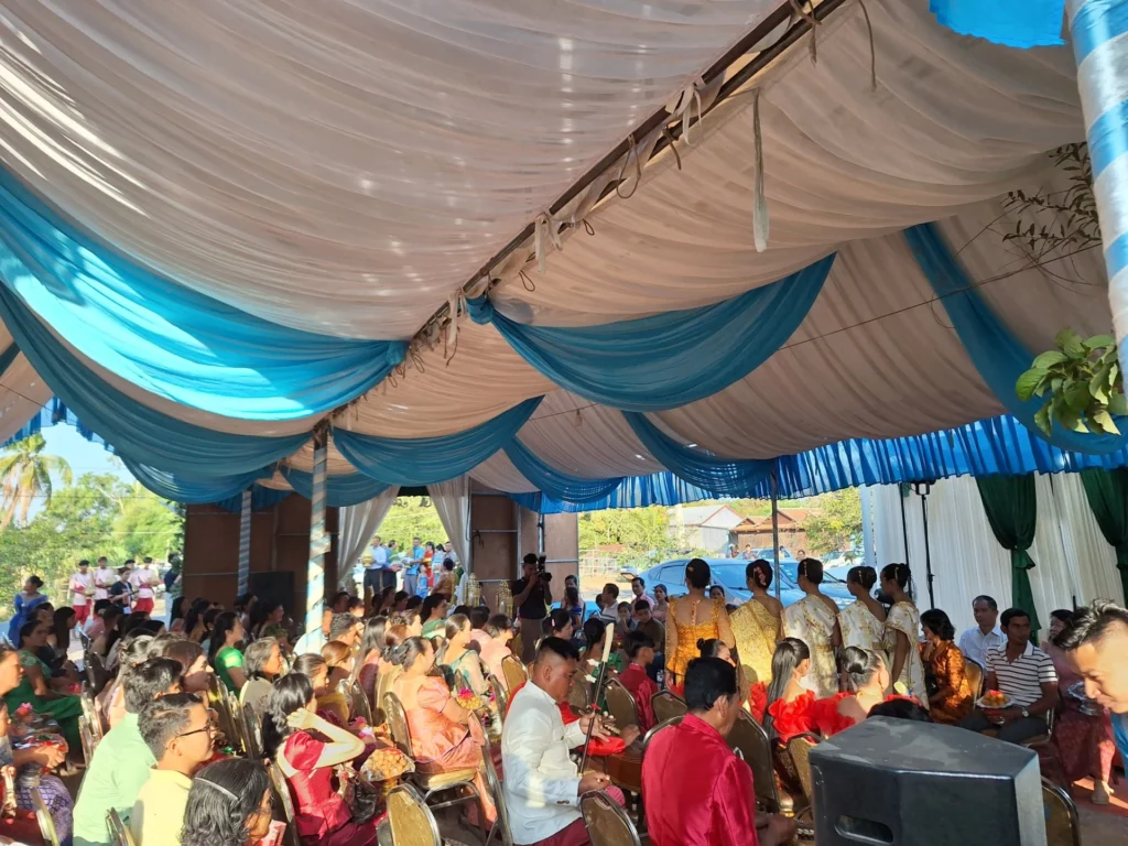Inside the wedding tent with a large seated audience