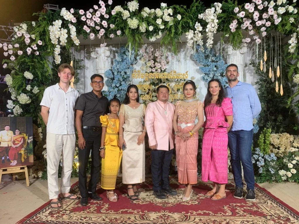 Ourselves, host family, and bride and groom standing for a photo at the wedding entrance
