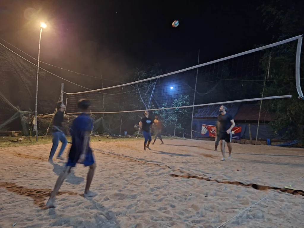 Volleyball game by night at a floodlit court